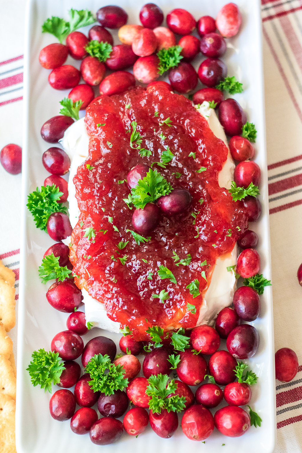 Cranberry Pepper Jelly Dip is just 3 ingredients and everyone's favorite festive appetizer! Comes together in just minutes, perfect for the holidays!