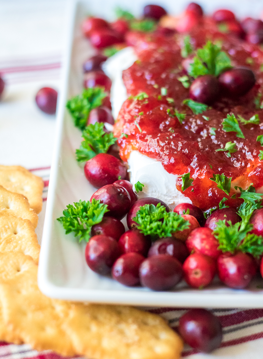 Cranberry Pepper Jelly Dip is just 3 ingredients and everyone's favorite festive appetizer! Comes together in just minutes, perfect for the holidays!