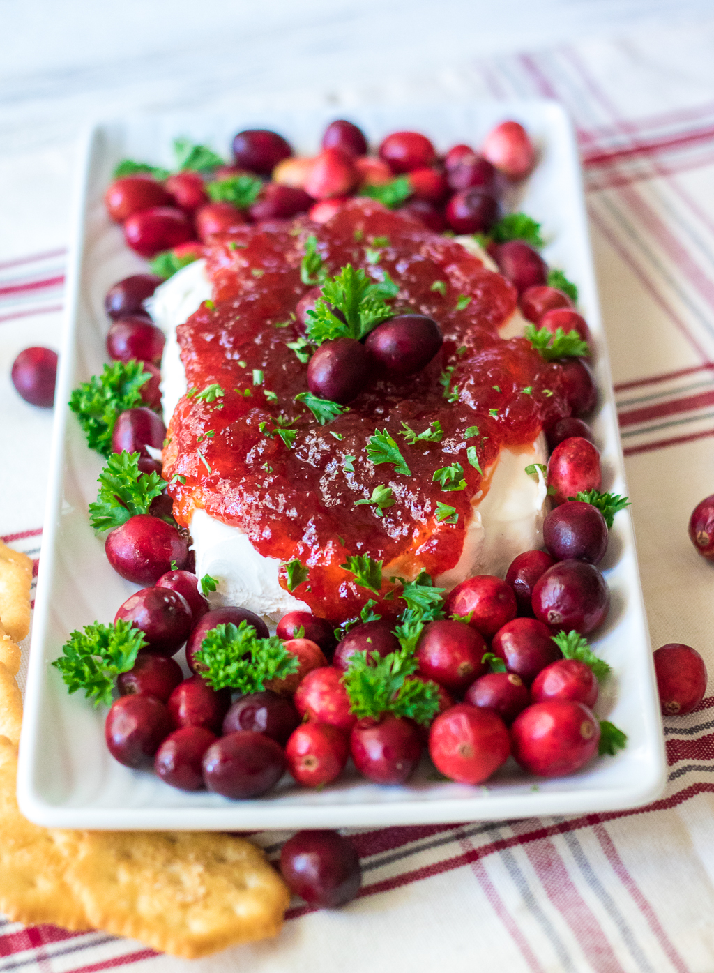 Cranberry Pepper Jelly Dip is just 3 ingredients and everyone's favorite festive appetizer! Comes together in just minutes, perfect for the holidays!