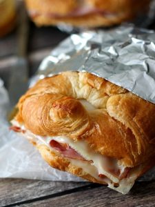 Hot Ham & Swiss Croissants, buttery croissants, melty cheese and a honey mustard sauce all melt together to make the perfect sandwich.