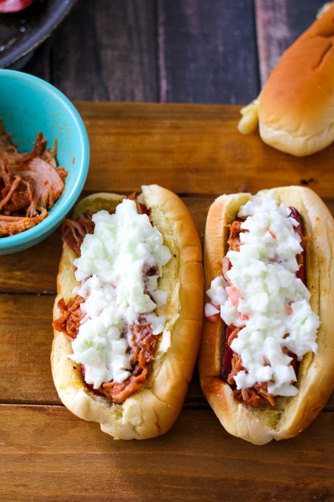 Pulled Pork Spicy Slaw Dogs are going to be your new favorite dish this summer!! Comes together super quick. Perfect easy dinner!
