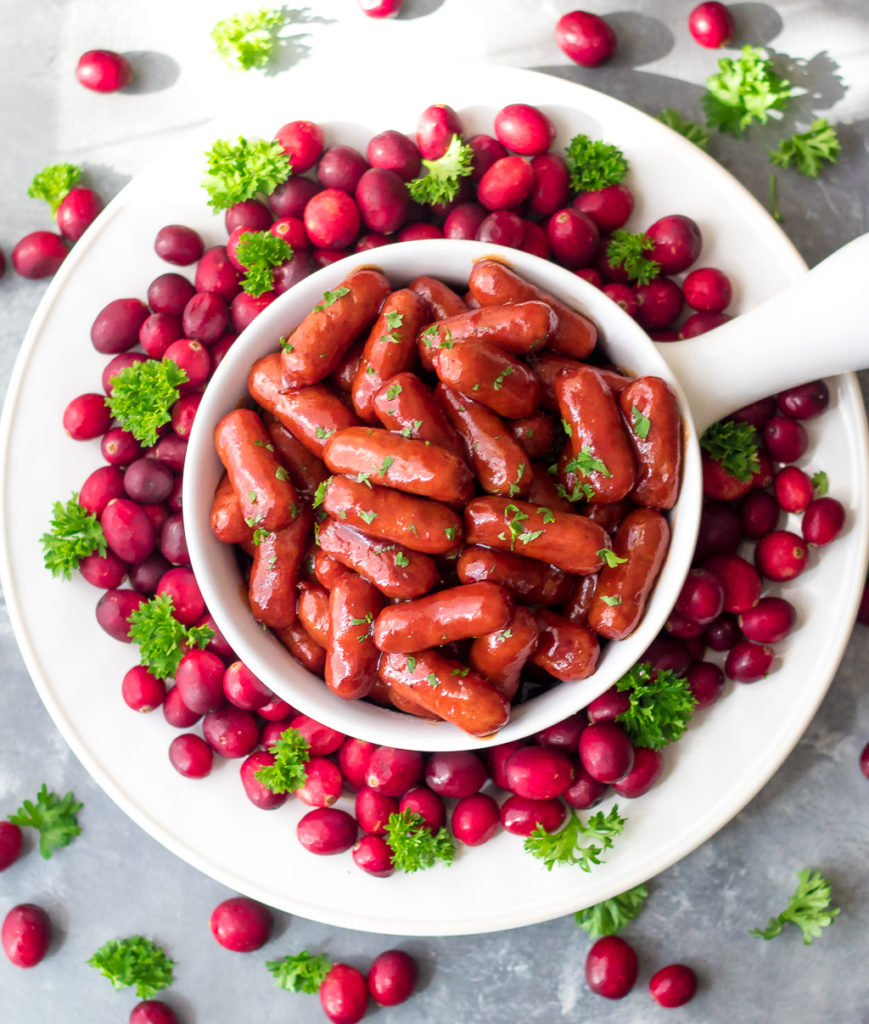 Slow Cooker Cranberry BBQ Little Smokies are the perfect holiday appetizer! Just 4 ingredients in the slow cooker to make this festive delicious dish!