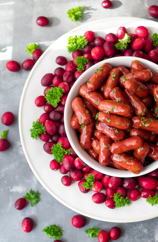 Slow Cooker Cranberry BBQ Little Smokies are the perfect holiday appetizer! Just 4 ingredients in the slow cooker to make this festive delicious dish!