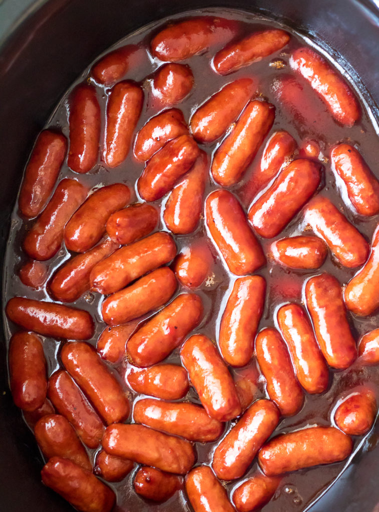 Slow Cooker Cranberry BBQ Little Smokies are the perfect holiday appetizer! Just 4 ingredients in the slow cooker to make this festive delicious dish!