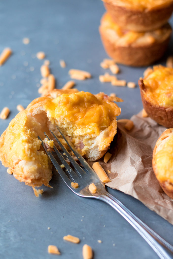 Cheesy Ham & Egg Biscuit Cups are an easy and delicious breakfast. Egg, cheese and ham all baked up in a biscuit cup is breakfast perfection!