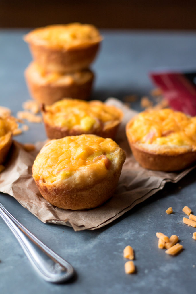 Cheesy Ham & Egg Biscuit Cups are an easy and delicious breakfast. Egg, cheese and ham all baked up in a biscuit cup is breakfast perfection!