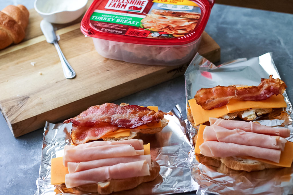 Turkey Bacon Ranch Melts are your new favorite sandwich!! Melty cheese, crispy bacon, turkey and ranch all warm and tucked into a buttery croissant.
