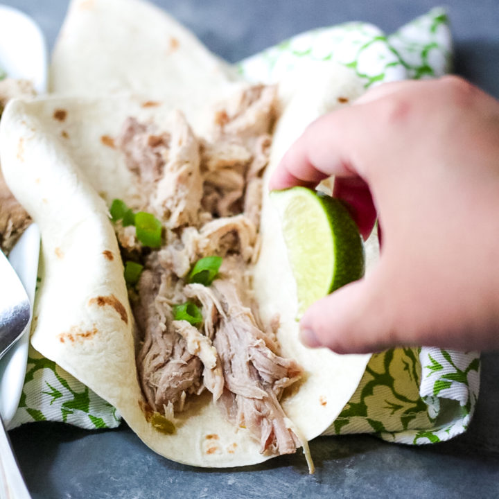 Slow Cooker Green Chile Pork is the 5 ingredient dinner that is ready when you are! You can use it in so many ways, like tacos!