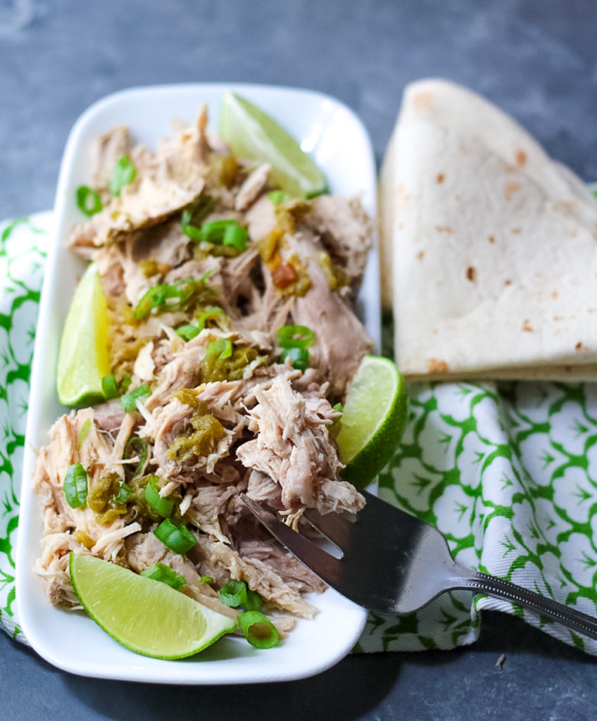 Slow Cooker Green Chile Pork is the 5 ingredient dinner that is ready when you are! You can use it in so many ways, like tacos!