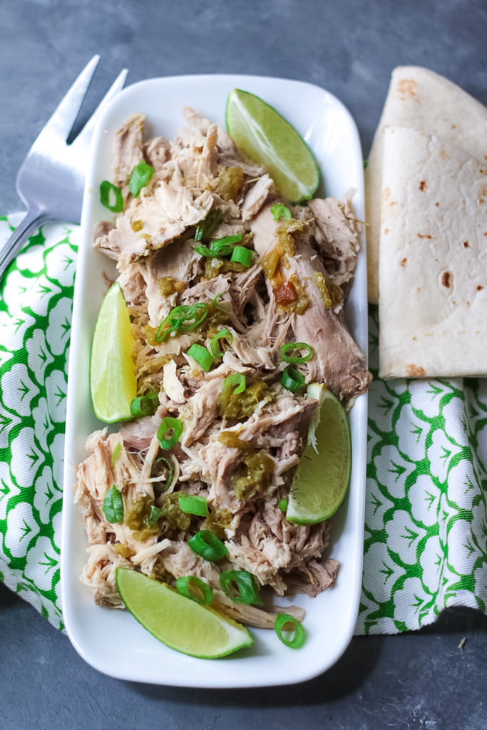 Slow Cooker Green Chile Pork is the 5 ingredient dinner that is ready when you are! You can use it in so many ways, like tacos!