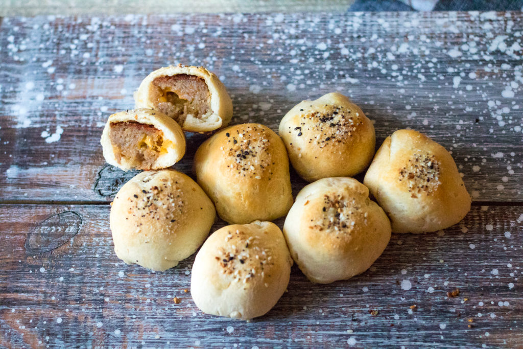 Sausage Ball Biscuit Bombs are stuffed with cheese and then baked in a biscuit bomb and topped with everything bagel seasoning to create the perfect bite!