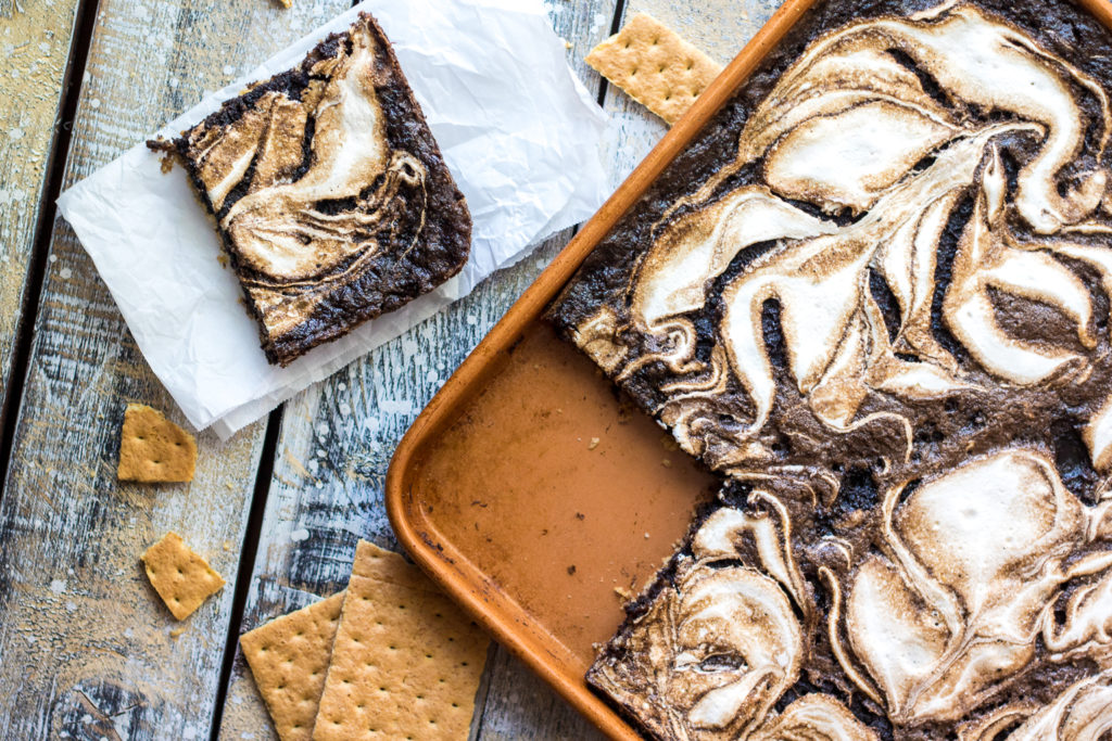 S'mores Slab Pie is the perfect dessert! Graham cracker crust, fudgy pie and that marshmallow swirl are out of this world!