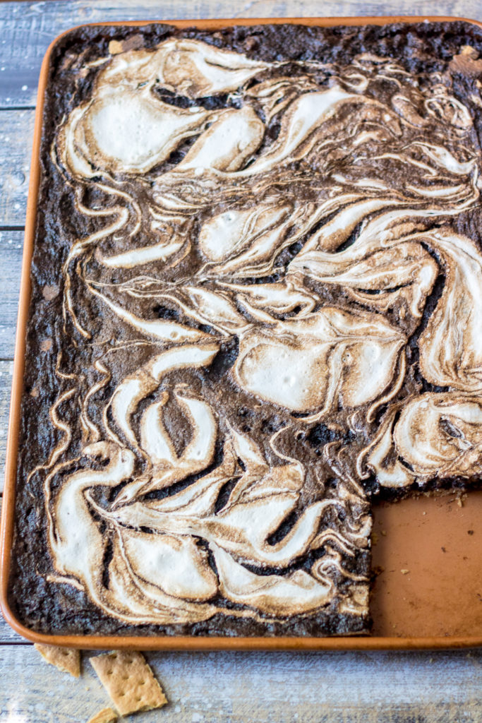 S'mores Slab Pie is the perfect dessert! Graham cracker crust, fudgy pie and that marshmallow swirl are out of this world!