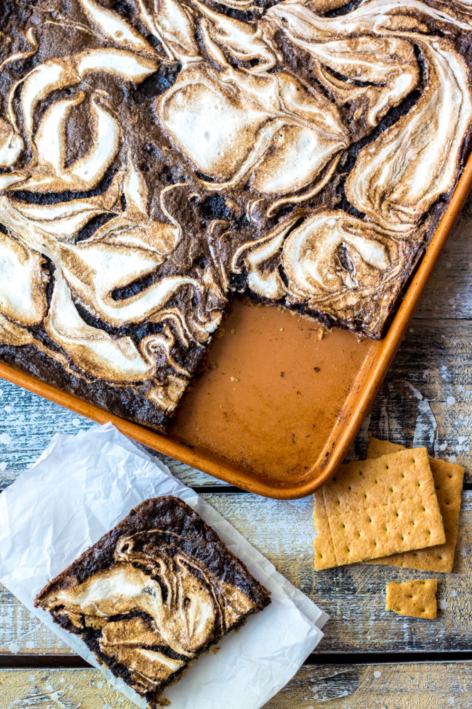 S'mores Slab Pie is the perfect dessert! Graham cracker crust, fudgy pie and that marshmallow swirl are out of this world!