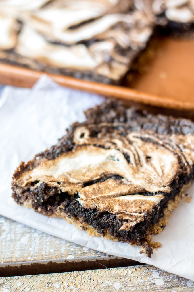 S'mores Slab Pie is the perfect dessert! Graham cracker crust, fudgy pie and that marshmallow swirl are out of this world!