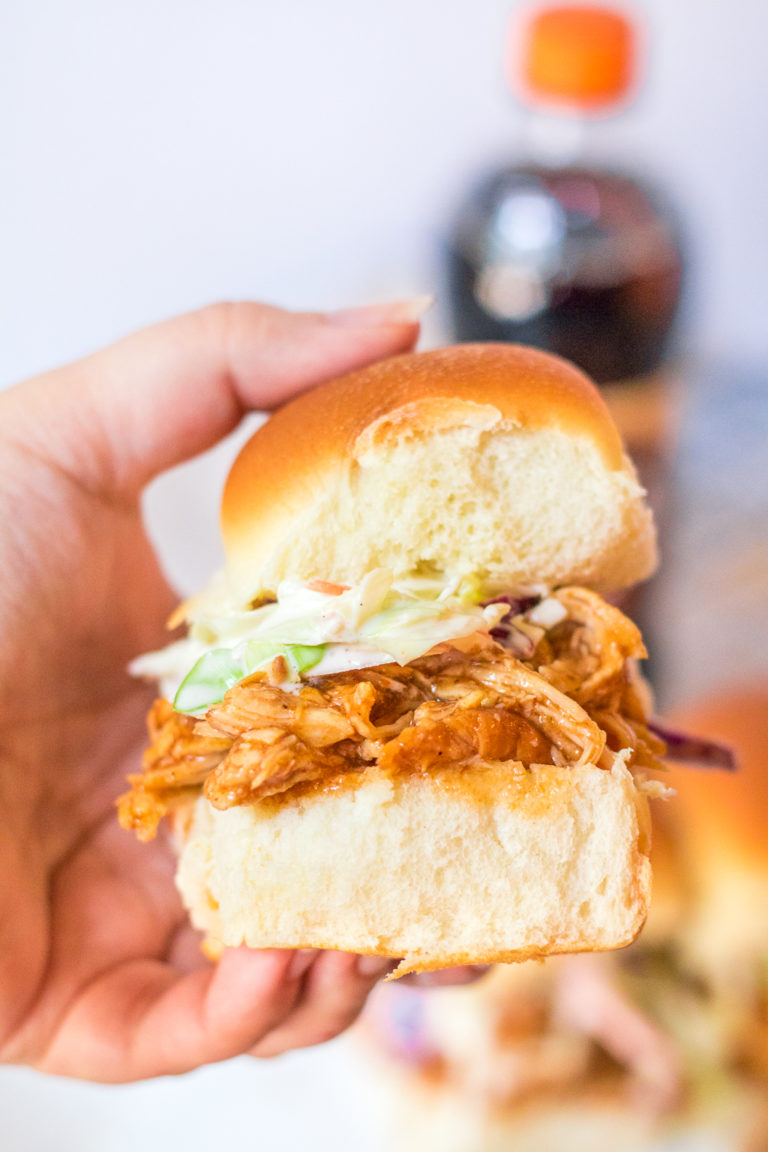 Slow Cooker Root Beer BBQ Sliders are the perfect dinner for summer! Flavorful slow cooked chicken piled on soft slider buns with a scoop of coleslaw, yum!