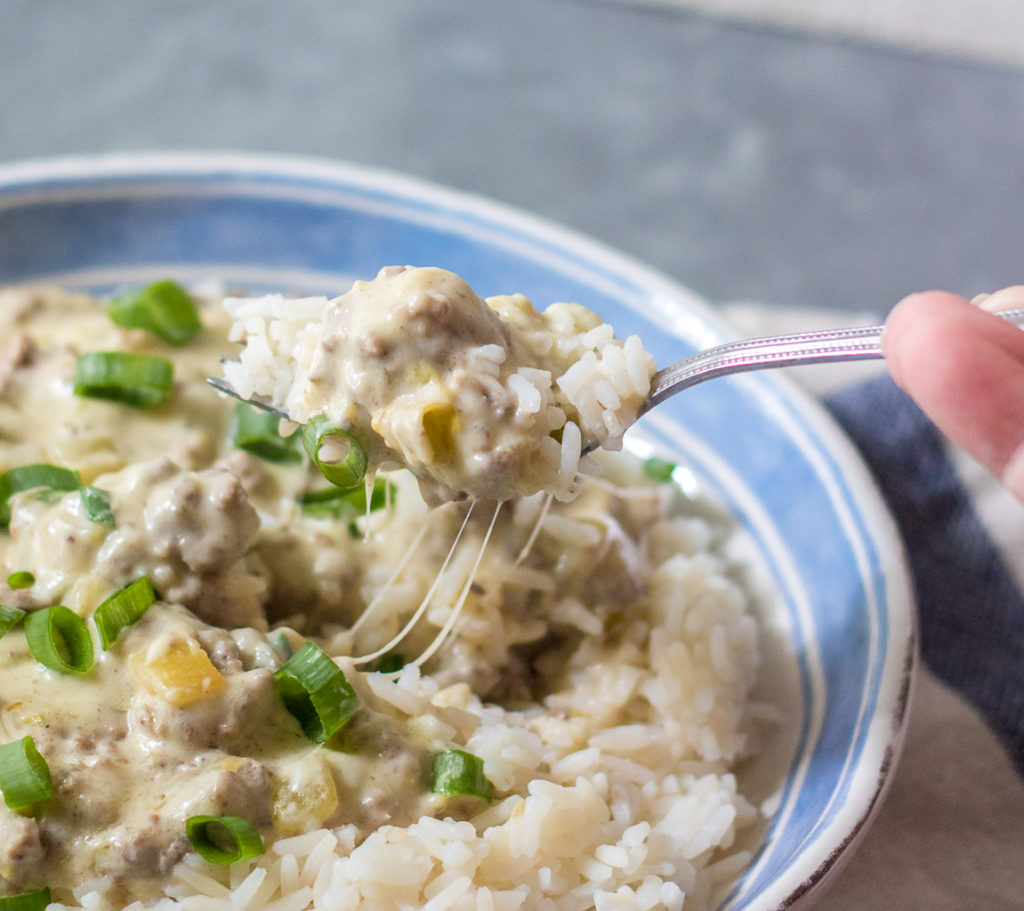 Cheesy Green Chile Beef & Rice is the perfect, easy, quick dinner that everyone will love! Full of flavor but not too spicy it is a crowd pleaser!