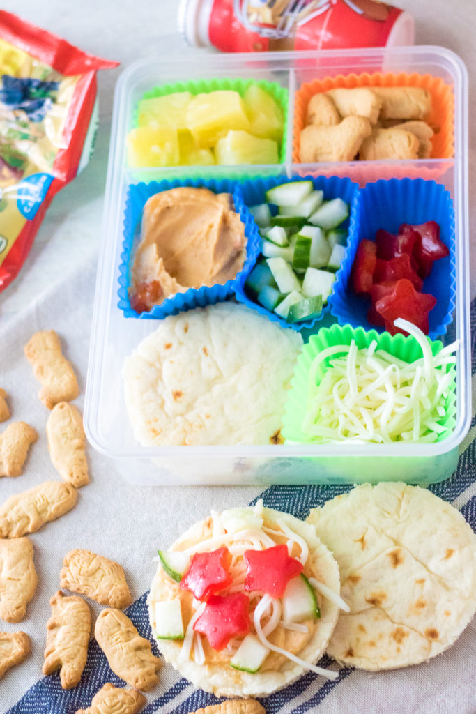 DIY Mediterranean Pizza Lunch Box is a fun and delicious lunch your kids can make themselves! Perfect for back to school and a change from sandwiches!