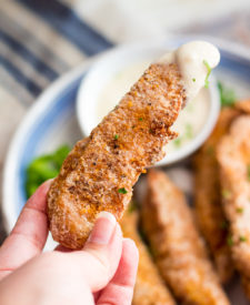 Garlic Parmesan Crispy Chicken Tenders have a secret ingredient to make them the crispiest chicken tenders, with a creamy garlic parm sauce for dipping!