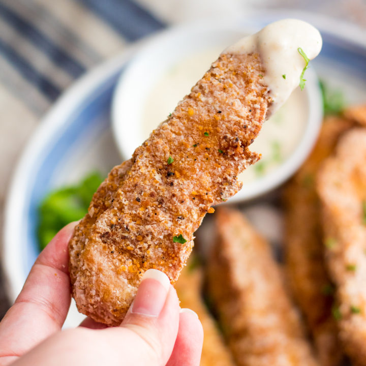 Garlic Parmesan Crispy Chicken Tenders have a secret ingredient to make them the crispiest chicken tenders, with a creamy garlic parm sauce for dipping!