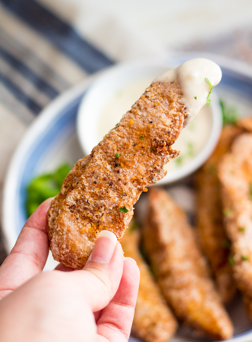 Garlic Parmesan Crispy Chicken Tenders have a secret ingredient to make them the crispiest chicken tenders, with a creamy garlic parm sauce for dipping!