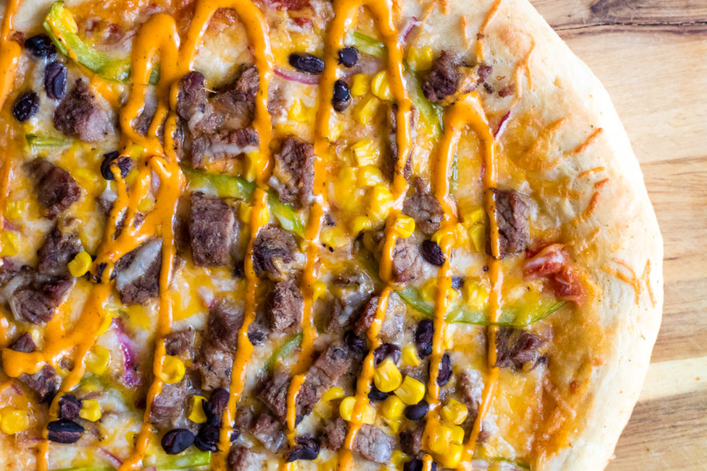 Steak Fajita Pizza will be your new favorite! Homemade crust topped with steak, corn, black beans and peppers and onions make the BEST pizza!