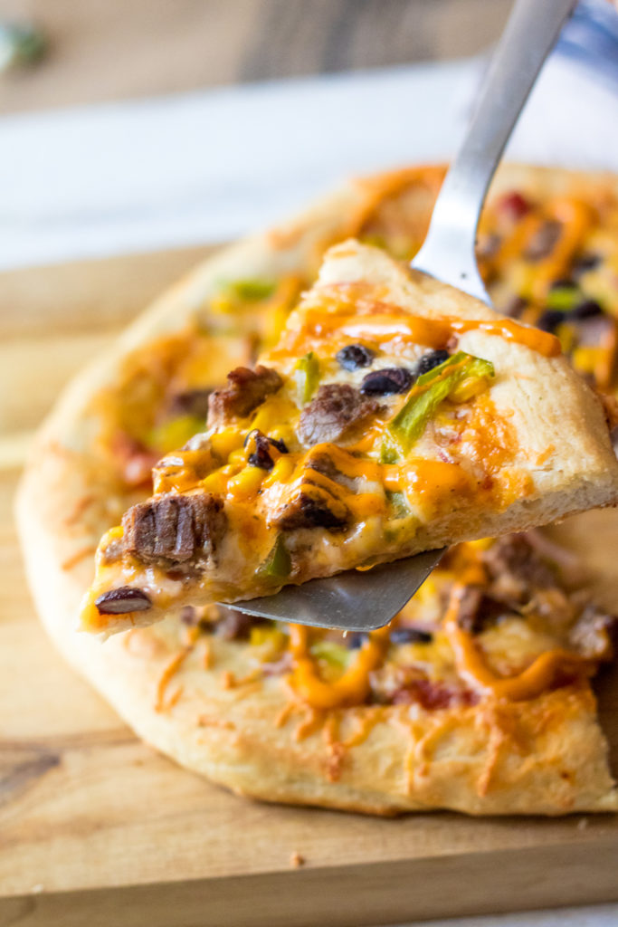 Steak Fajita Pizza will be your new favorite! Homemade crust topped with steak, corn, black beans and peppers and onions make the BEST pizza!