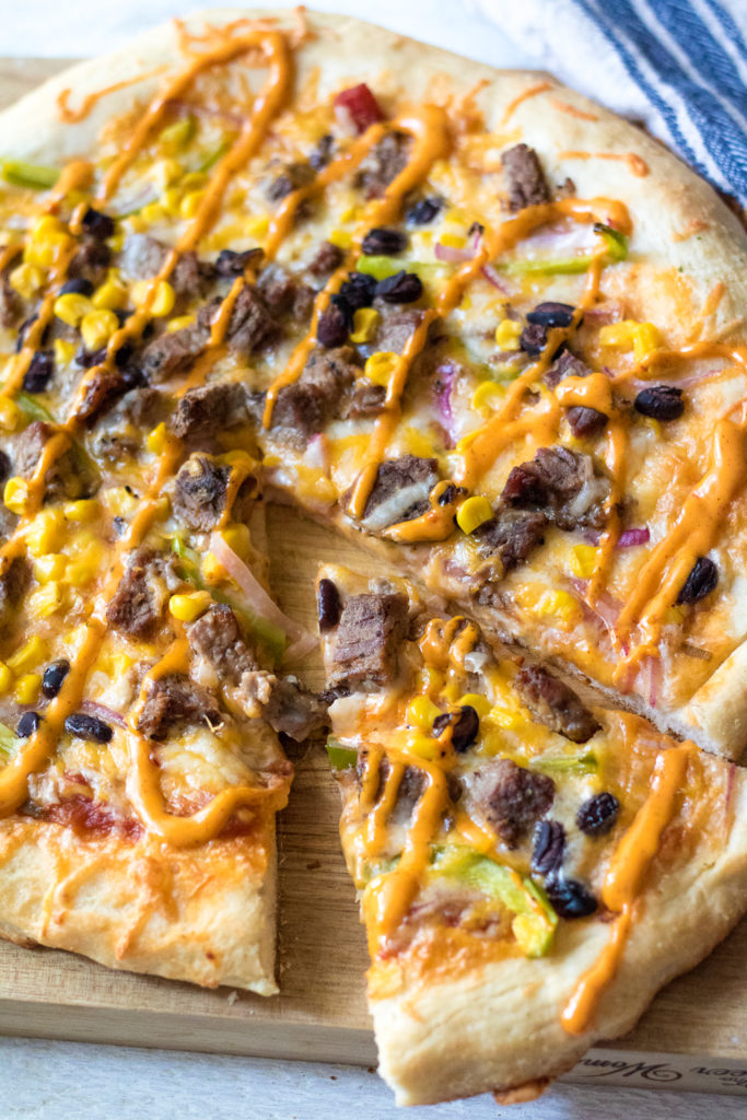 Steak Fajita Pizza will be your new favorite! Homemade crust topped with steak, corn, black beans and peppers and onions make the BEST pizza!