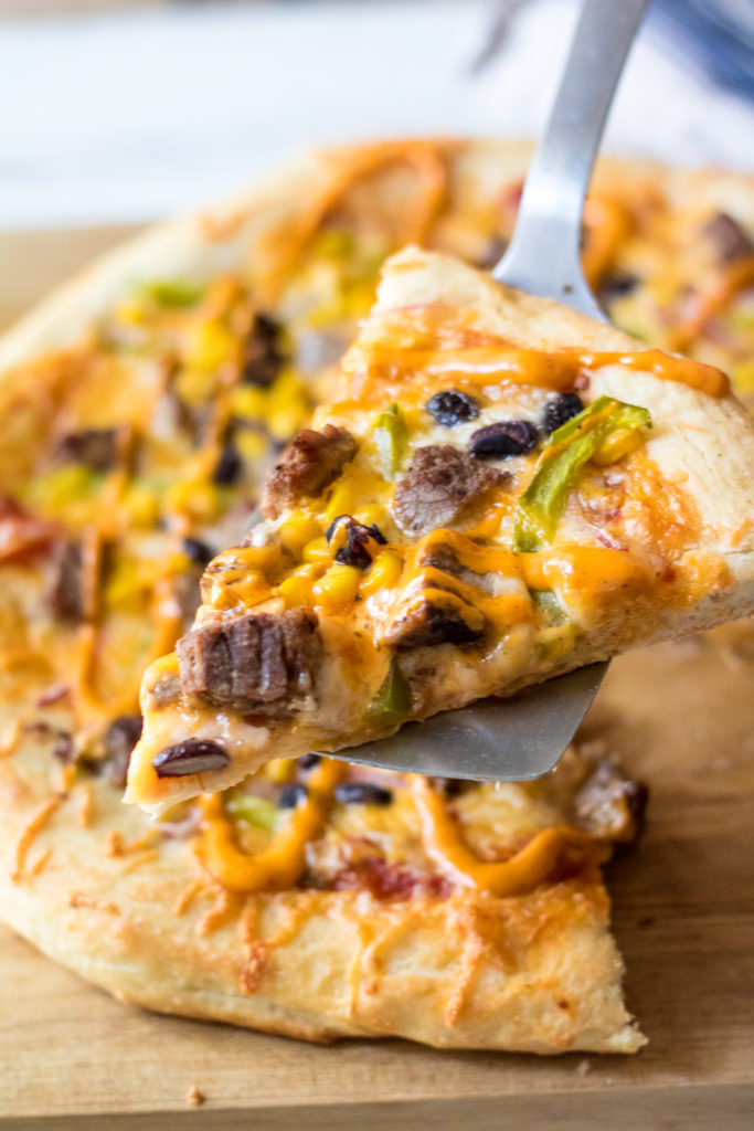 Steak Fajita Pizza will be your new favorite! Homemade crust topped with steak, corn, black beans and peppers and onions make the BEST pizza!