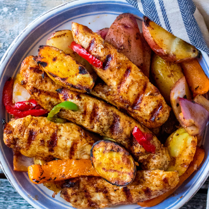 Chicken Fajita Hash is my new favorite thing to grill! Tender marinated chicken on top of grilled potatoes and veggies, yum!