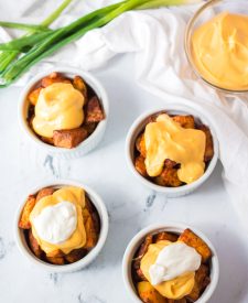 Seasoned potatoes get nice and crispy before getting topped with nacho cheese, sour cream and green onions, yum!