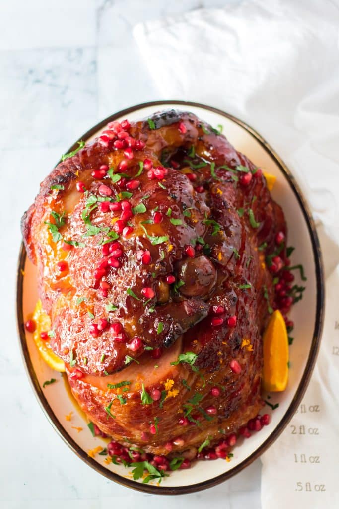 Orange juice, brown sugar, honey and cinnamon make up a deliciousOrange zest, pomegranate seeds and parsley give this ham it’s festive colors.