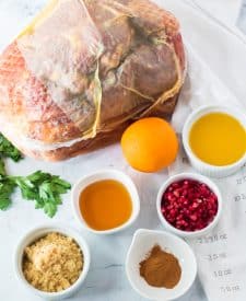 Ham, oranges, orange juice, pomegranate seeds, brown sugar, spices, honey, parsley