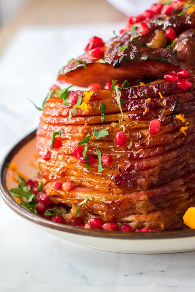 Orange juice, brown sugar, honey and cinnamon make up a deliciousOrange zest, pomegranate seeds and parsley give this ham it’s festive colors.