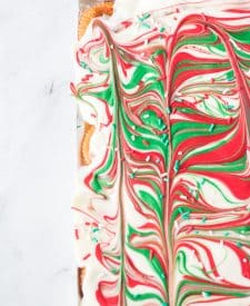 White, red and green melted chocolate swirled