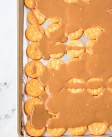 Ritz crackers on sheet pan with caramel mixture poured over