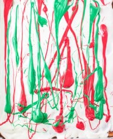 White, red and green melting chocolate over crackers