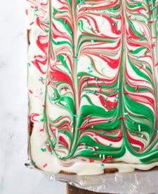 White, red and green melted chocolate swirled