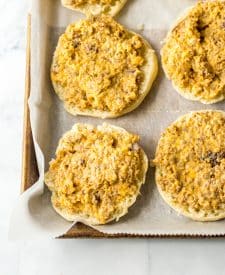 Unbaked old english sausage muffins on sheet pan.