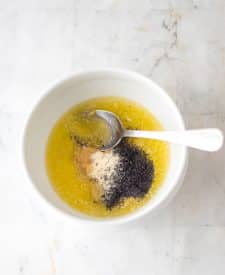 Melted butter, worcheshire sauce, poppy seeds and onion powder in a bowl.