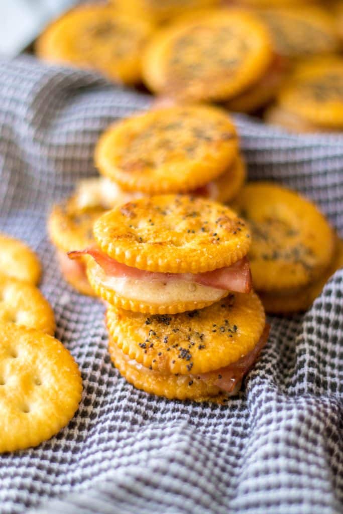 Ritz Cracker Sandwiches stacked to show ham and swiss inside.