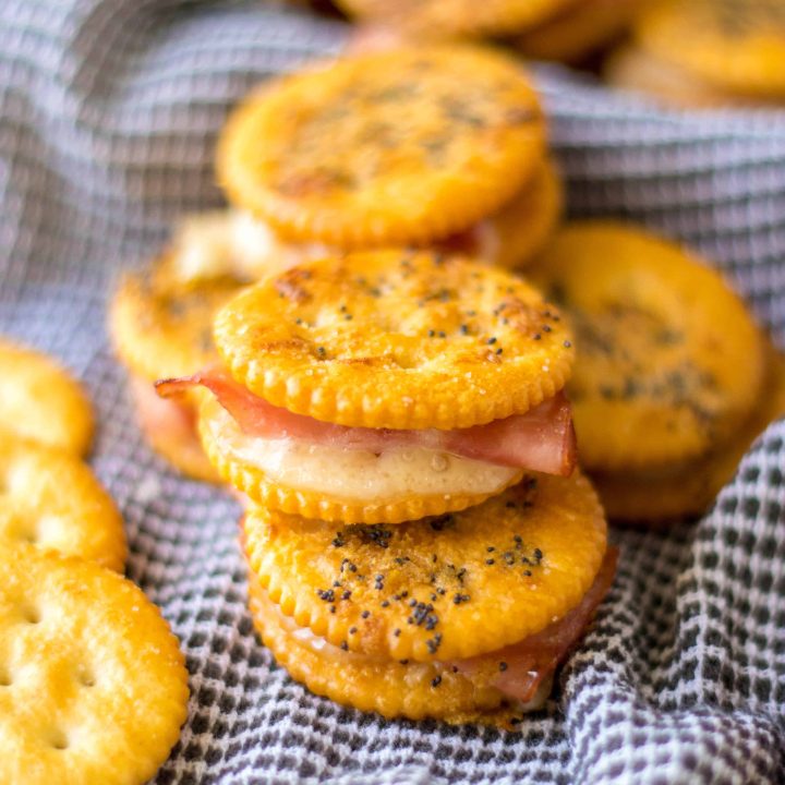 Ritz Cracker Sandwiches stacked to show ham and swiss inside.