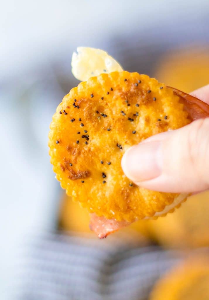 Hand holding Ritz Cracker Sandwich.