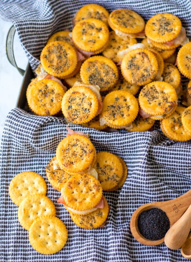 Overhead shot of Ritz Cracker Sandwiches with some piled in a tray.