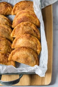 Caramel Apple Empanadas baked up and lined up in a serving dish