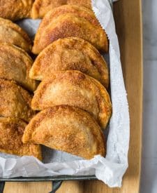 Caramel Apple Empanadas baked up and lined up in a serving dish