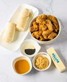 Glazed Chicken Bites ingredient shot, popcorn chicken , crescent rolls, butter, mustard, honey, poppyseeds, onion powder