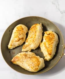 Chicken breasts browning in pan