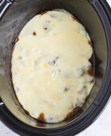 Slow Cooker Philly Cheesesteak Bites in slow cooker topped with cheese