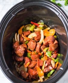 Slow Cooker Philly Cheesesteak Bites all mixed together in slow cooker before cooking